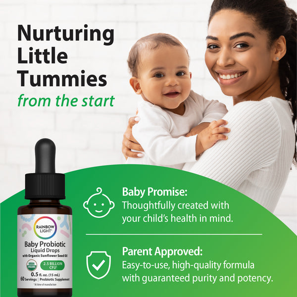 A smiling young woman holds a baby next to a Rainbow Light Baby Probiotic Liquid Drops bottle.