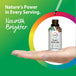 Adult hand presenting Super Yohimbe Liquid Extract bottle as a dropper dispenses liquid, against a bright green and rainbow background.